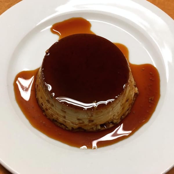 Mexican flan dessert with rich caramel sauce on a white plate at Sol Azteca.